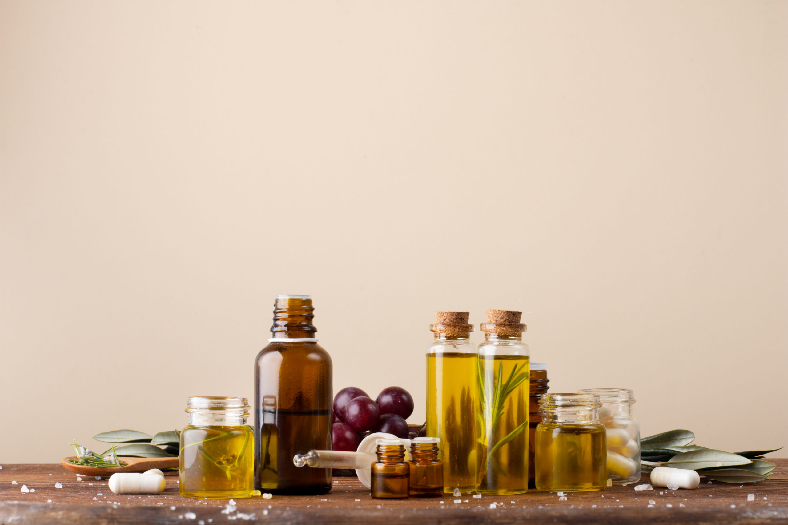 front-view-plastic-bottles-with-oil-medicine-table_093656